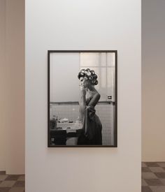 a black and white photo hanging on the wall