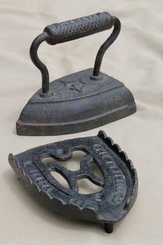 two old irons sitting on top of a white sheet