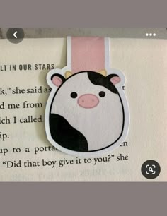 a bookmark with a cow on it's face