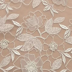 an embroidered lace with flowers and leaves on it