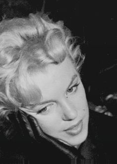 a black and white photo of a woman with blonde hair