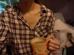 a woman holding a coffee mug in her hands