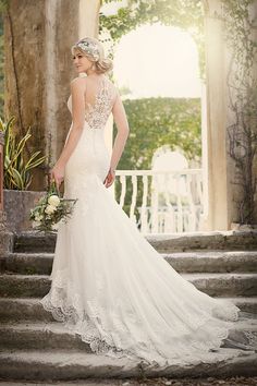 a woman in a wedding dress standing on some steps