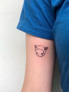 a small fox tattoo on the left arm