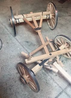 two wooden wheels on the ground next to each other