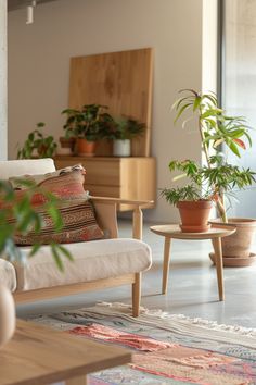 a living room filled with lots of plants on top of a wooden table next to a white couch