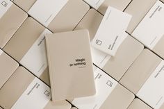 a book sitting on top of a computer keyboard next to some white and beige tiles