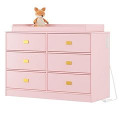 a stuffed animal is sitting on top of a pink dresser with gold handles and drawers