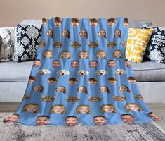 a blue blanket with photos of people on it and a dog in the middle is laying down