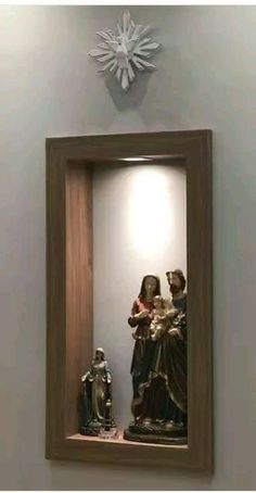 an image of the virgin mary and child jesus in a wooden frame hanging on the wall