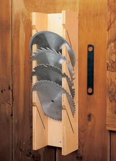 four circular saws are attached to a wooden board