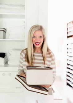 a woman holding a laptop computer in her hands