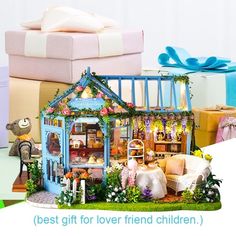 there is a doll house in the middle of many boxes with presents around it and an open gift box next to it