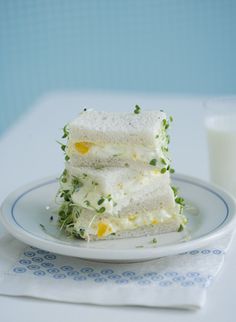 three pieces of cake sitting on top of a plate next to a glass of milk