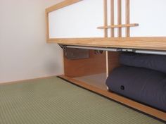 there is a bunk bed in the room with two pillows on it and a rug underneath