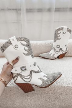 Made with white leather and adorned with crystal rhinestones and a silver chain, this statement boot is sure to turn heads. Heel height is 3.25" Sequin Tassel Dress, Girl Boss Book, Fringe Mini Dress, Amazing Lace, Western Booties, Native Style, White Rhinestone, For Love And Lemons, Concert Outfit