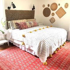 a bedroom with a large bed and lots of decorations on the wall