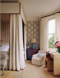 a bedroom with a bed, desk and chair next to a window in the room