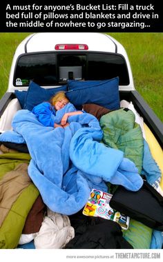 a black and white photo of a child sleeping in the back of a truck