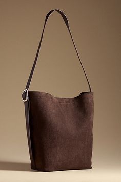 Polyester shell; polyurethane lining and strap One top-zip removable pouch Magnetic closure Imported | Faux-Suede North South Bucket Bag by Anthropologie in Brown, Women's, Polyester/Polyurethane Brown Suede Bag, Slouch Bags, Suede Purse, Suede Bag, Xmas List, North South, Christmas Wishlist, Magnetic Closure, Faux Suede