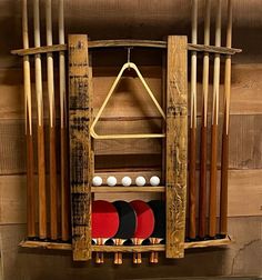 a wooden rack with several different types of paddles