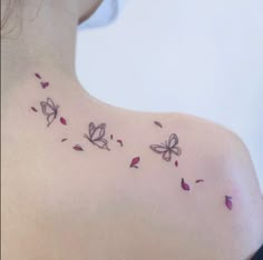 the back of a woman's shoulder with butterflies on it