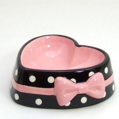 a pink and black polka dot dog bowl with a bow tie on the side,