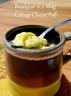 a mug filled with cottage cheese puff on top of a wooden table