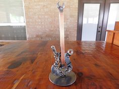 a metal sculpture sitting on top of a wooden table