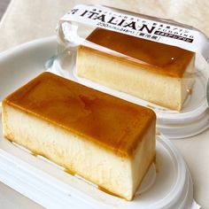 two pieces of cake sitting on top of a white plate next to a container of caramel