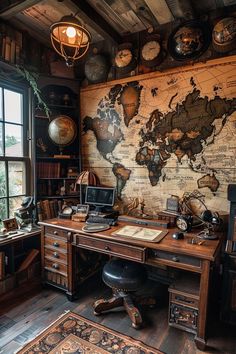 an old world map is on the wall behind a desk with a laptop and lamp