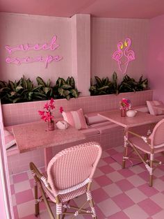 the interior of a pink restaurant with flamingos painted on the walls