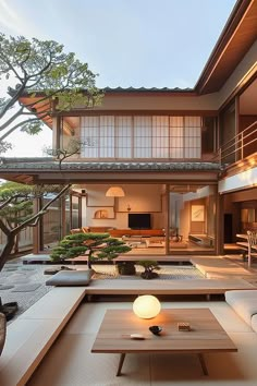 an outdoor living room and dining area in a japanese style house with wood floors, white furniture and large windows