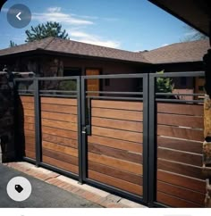 an image of a wooden gate in front of a house