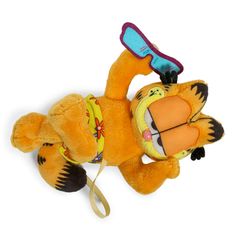 a stuffed animal laying on its back with a toothbrush in it's mouth