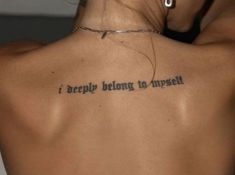 a woman with a tattoo on her back saying i deeply belong to yourself