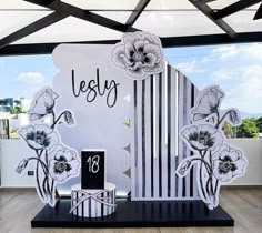 the display is decorated with black and white flowers