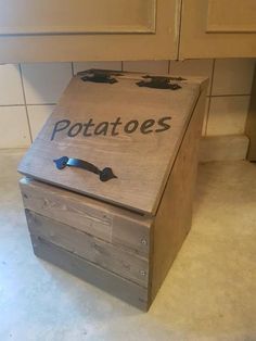 a wooden box with the word potatoes written on it