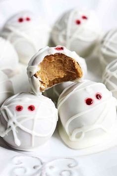 some white chocolates with red eyes and one has a bite taken out of it