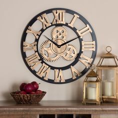 a clock that is on the side of a wall next to a basket of apples