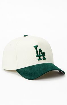 a white and green baseball cap with the los angeles dodgers on it