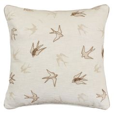 a white pillow with birds on it