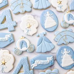 decorated cookies are displayed on a table for the first birthday boy to be born in blue and white