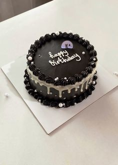 a black and white cake sitting on top of a table