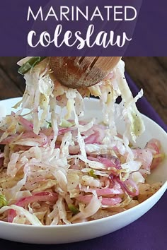 a white bowl filled with coleslaw on top of a purple cloth covered table