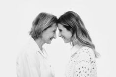 two women are laughing together in black and white