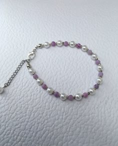 Delicate pearl bracelet, purple agate gemstone and white pearls, adjustable. This dainty pearl bracelet is simple and elegant. Glass pearls are coated in coloured lacquer to give a beautiful lustre finish. A beautiful gift for any occasion. Comes in its own gift box. Adjustable Crystal Bracelet With Pearl Charm, Purple Pearl Bracelet As A Gift, Elegant Purple Pearl Bracelet With Round Beads, Elegant Handmade Purple Pearl Bracelet, Handmade Elegant Purple Pearl Bracelet, Handmade Adjustable Pearl Crystal Bracelet, Purple Beaded Pearl Bracelets, Purple Beaded Pearl Bracelet, Purple Pearl Bracelet As Gift