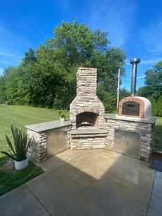 an outdoor pizza oven in the middle of a yard