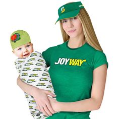 a woman holding a baby wearing a green hat and shirt with the word joy way on it