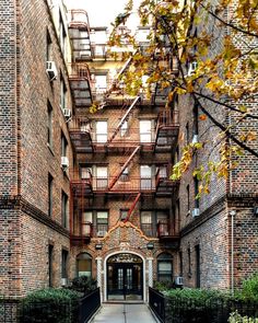 an apartment building with brick walls and balconies